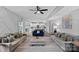Spacious open-concept living room flows into kitchen with gray, white, and blue decor at 7331 Millstone Sw Cir, Concord, NC 28025