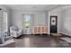 Comfortable living room featuring hardwood floors and large window at 7331 Millstone Sw Cir, Concord, NC 28025