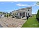 Expansive stone patio featuring seating, outdoor cooking area, and screened in porch for entertaining and relaxing at 7331 Millstone Sw Cir, Concord, NC 28025