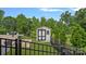 A charming white storage shed with black trim nestled in the backyard, enhancing the property's organization at 7331 Millstone Sw Cir, Concord, NC 28025