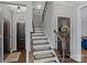 Traditional staircase with decorative railing and wood trim details at 7331 Millstone Sw Cir, Concord, NC 28025