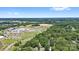 Scenic aerial shot of property close to school facilities, expansive green spaces and surrounding trees at 800 Davenport St, Monroe, NC 28112