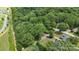 An aerial view of a house in a wooded area with neighboring homes in a residential neighborhood at 800 Davenport St, Monroe, NC 28112