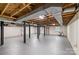 Spacious unfinished basement with exposed beams and painted floors at 800 Davenport St, Monroe, NC 28112