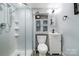 This bathroom features a stand-up shower, toilet, sink vanity, and decorative mirror providing a modern and efficient space at 800 Davenport St, Monroe, NC 28112