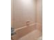 A standard bathtub with a shower head surrounded by pink tiling at 800 Davenport St, Monroe, NC 28112