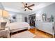 Comfortable bedroom featuring hardwood floors, a ceiling fan, and plantation shutters at 800 Davenport St, Monroe, NC 28112