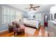 Comfortable bedroom featuring hardwood floors, a ceiling fan, and plantation shutters at 800 Davenport St, Monroe, NC 28112