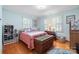 Charming bedroom with hardwood floors, natural light from shuttered windows, and cozy decor offers a relaxing and inviting personal space at 800 Davenport St, Monroe, NC 28112