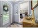 Inviting entryway with warm wood accents, decor, a mirror, and a glimpse into the living space creating a welcoming first impression at 800 Davenport St, Monroe, NC 28112