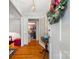 Inviting foyer features hardwood floors, a vintage table, and a decorative floral wreath at 800 Davenport St, Monroe, NC 28112