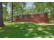 Charming brick home with a beautifully landscaped front yard and a welcoming entrance with brick steps at 800 Davenport St, Monroe, NC 28112