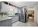 Grey cabinets with granite countertops and stainless steel appliances in the updated kitchen at 800 Davenport St, Monroe, NC 28112