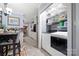 Convenient laundry room features a washer and dryer, built-in shelving, and ample storage space for a functional and organized utility area at 800 Davenport St, Monroe, NC 28112