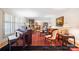 Bright living room features large windows, shutters, piano and stylish furnishings at 800 Davenport St, Monroe, NC 28112