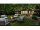 Outdoor patio area is a perfect spot for entertaining, complete with a stylish stone firepit and comfy seating at 8321 Walkup Rd, Waxhaw, NC 28173