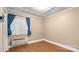 Bright bedroom features a large window, hardwood floors, and a comfortable atmosphere at 8321 Walkup Rd, Waxhaw, NC 28173