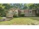 Attractive home featuring a cozy front porch and a well-kept lawn, inviting you to relax outdoors at 8321 Walkup Rd, Waxhaw, NC 28173
