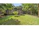 Quaint home with lush green lawn and mature trees creating a serene and private outdoor space at 8321 Walkup Rd, Waxhaw, NC 28173