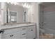 Bathroom featuring double sinks and a tub with shower at 8928 Morning Mist Rd, Charlotte, NC 28215