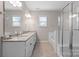 Bright bathroom with granite countertop, a soaking tub, and modern glass enclosed shower at 8928 Morning Mist Rd, Charlotte, NC 28215