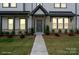 Attractive home with a well-manicured lawn and welcoming front entrance at 8928 Morning Mist Rd, Charlotte, NC 28215