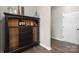 Hallway featuring luxury vinyl floors and a dark wood curio cabinet at 8928 Morning Mist Rd, Charlotte, NC 28215