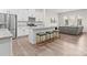 Bright kitchen featuring white cabinets, granite countertops, stainless steel appliances, and a central island with bar stools at 8928 Morning Mist Rd, Charlotte, NC 28215