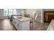 Open floor plan from kitchen with island into living room and dining area at 8928 Morning Mist Rd, Charlotte, NC 28215