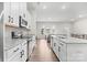 Open kitchen featuring white cabinets, granite countertops, stainless steel appliances, and an island with sink at 8928 Morning Mist Rd, Charlotte, NC 28215