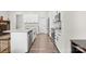 Bright kitchen with white cabinets, granite countertops, stainless steel appliances, and view to the dining area at 8928 Morning Mist Rd, Charlotte, NC 28215