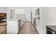 Bright kitchen with white cabinets, granite countertops, stainless steel appliances, and view to the dining area at 8928 Morning Mist Rd, Charlotte, NC 28215