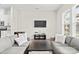 Cozy living room with comfortable seating and a large window offering natural light at 8928 Morning Mist Rd, Charlotte, NC 28215