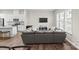 Comfortable living room and kitchen area featuring luxury vinyl floors and a large sectional sofa at 8928 Morning Mist Rd, Charlotte, NC 28215