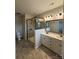 Bathroom featuring double sinks, quartz countertop, walk-in shower with glass door, and tile flooring at 9236 Ainslie Downs St, Charlotte, NC 28273