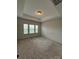 Bright, spacious bedroom featuring neutral tones and a tray ceiling, bathed in natural light from large windows at 9236 Ainslie Downs St, Charlotte, NC 28273