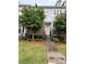 Charming townhouse featuring stone accents, manicured landscaping, and inviting entryway at 9236 Ainslie Downs St, Charlotte, NC 28273