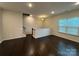 Cozy living room showcasing hardwood floors, recessed lighting, and staircase to upper level at 9236 Ainslie Downs St, Charlotte, NC 28273