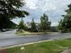 A well-maintained street view, lined with trees, showcasing community landscaping at 9236 Ainslie Downs St, Charlotte, NC 28273