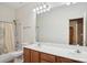 Well-lit bathroom with double vanity and shower-tub combo at 134 Lake Spring Loop, Mooresville, NC 28117