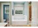Bright bathroom featuring a white bathtub, tiled shower, and neutral wall paint at 134 Lake Spring Loop, Mooresville, NC 28117