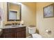Charming powder room with wood vanity, granite counter, and decorative mirror at 134 Lake Spring Loop, Mooresville, NC 28117