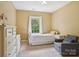 Inviting bedroom with a plush chair and natural light at 134 Lake Spring Loop, Mooresville, NC 28117