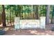 The Harbour Swim & Tennis Club community entrance sign is surrounded by towering trees on a wooded lot at 134 Lake Spring Loop, Mooresville, NC 28117
