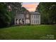 Beautiful two-story home with a brick facade, covered porch, and lush green lawn at 134 Lake Spring Loop, Mooresville, NC 28117