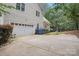 Attached two-car garage with a paved driveway and exterior lighting, great curb appeal at 134 Lake Spring Loop, Mooresville, NC 28117