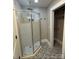 Sleek bathroom with a glass-enclosed shower featuring a rain shower head and a storage closet at 410 Gann St, Lowell, NC 28098