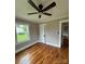 Cozy bedroom featuring hardwood floors, a ceiling fan, and a window with natural light at 410 Gann St, Lowell, NC 28098