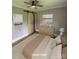 Bright bedroom featuring wood sliding doors, light dresser, and carpet floors at 410 Gann St, Lowell, NC 28098