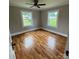 Bedroom with hardwood flooring and neutral paint; features a ceiling fan and great natural light at 410 Gann St, Lowell, NC 28098